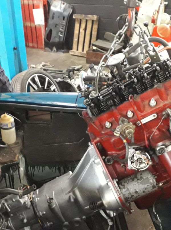 transmission being installed into a classic mg